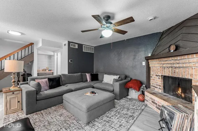 a living room with furniture a fireplace and a flat screen tv