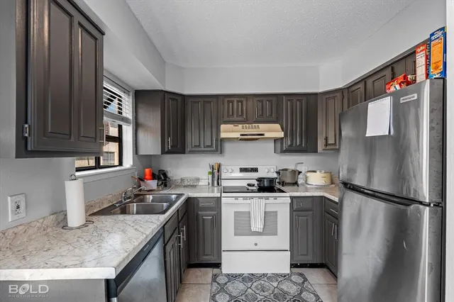 a refrigerator freezer sitting inside of a kitchen