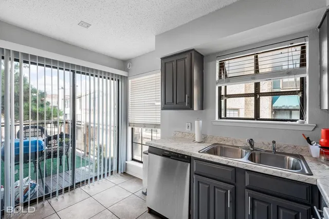 a kitchen with a stove a refrigerator and a sink with wooden floor
