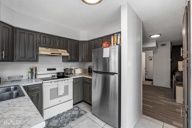 a view of a sink and a stove in a room
