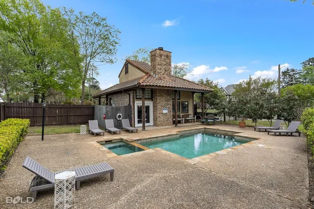 a view of a house with swimming pool and sitting area