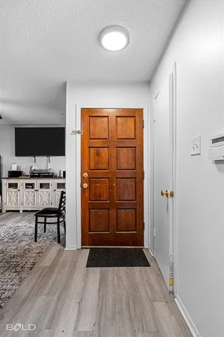 a view of a room with wooden floor and furniture