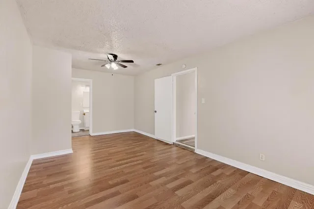 a view of an empty room with a ceiling fan