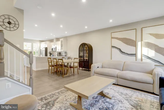 a living room with furniture a window and a table