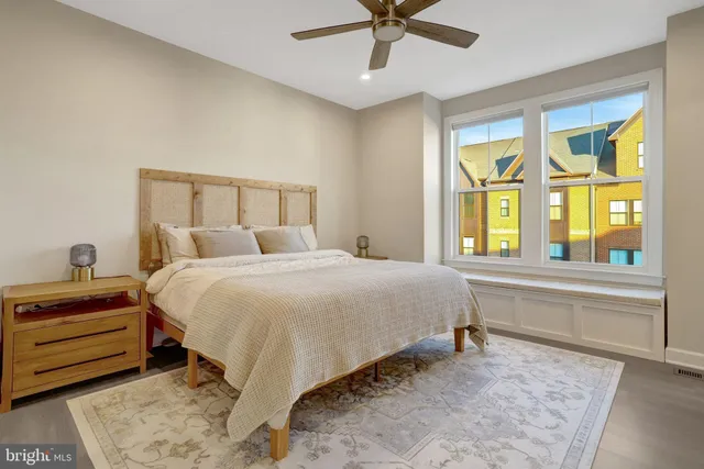 a bedroom with a bed and a large window