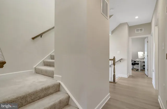 a view of a bedroom with wooden floor