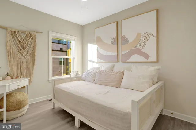 a bedroom with a bed and a painting on the wall