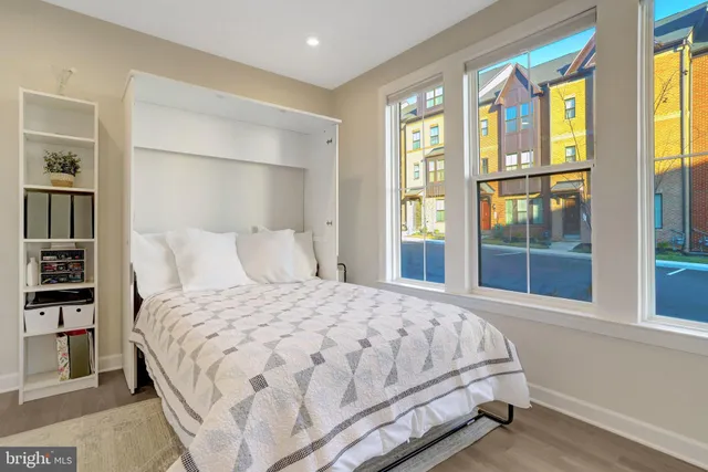 a bedroom with a bed and a view of walk in closet