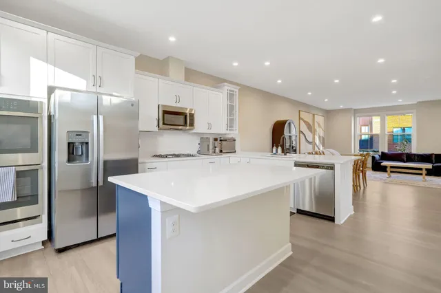 a kitchen with counter top space cabinets and stainless steel appliances