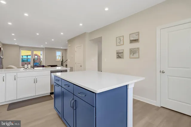 a kitchen with a stove a sink and a refrigerator