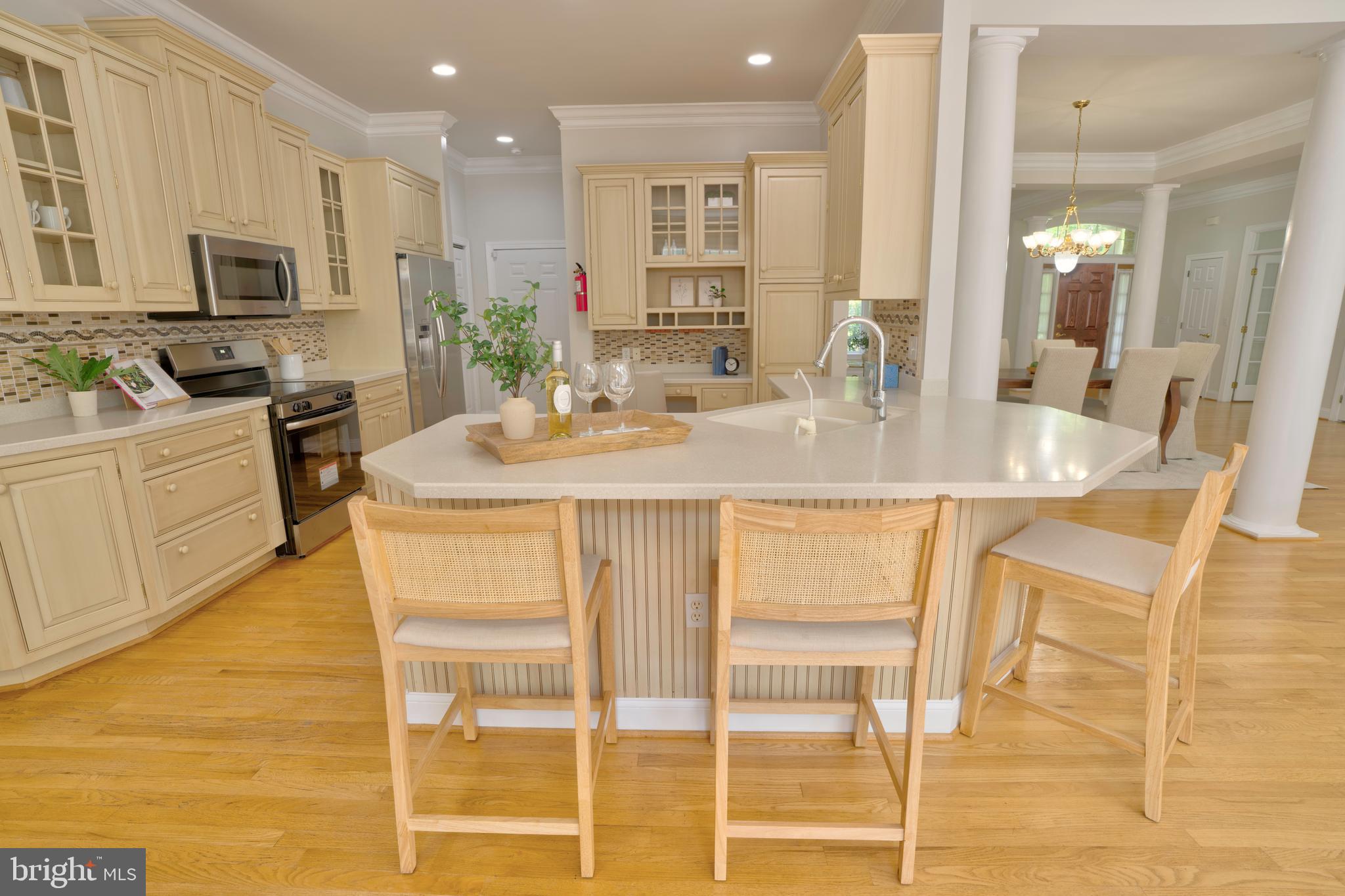 4300 Pinetree Road Rockville, MD 20853 - Photo 28 of 50 a kitchen with kitchen island granite countertop wooden cabinets and counter space