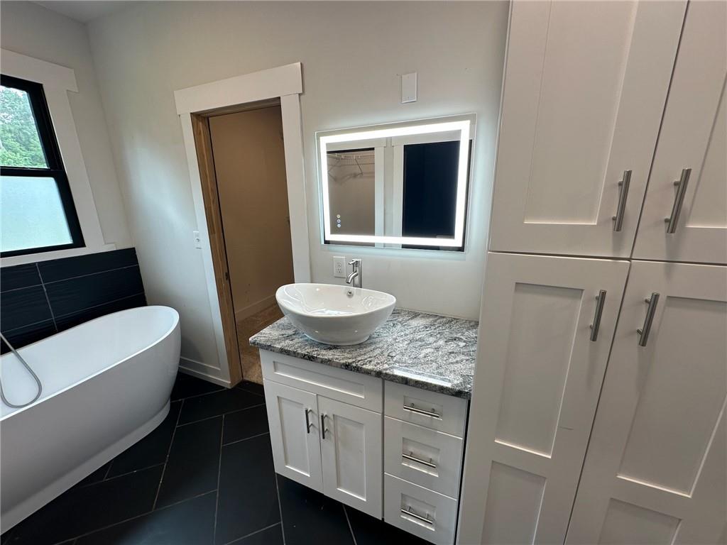 1001 Bailey Road Rome, GA 30161 - Photo 12 of 44 a bathroom with a sink and mirror with bathtub