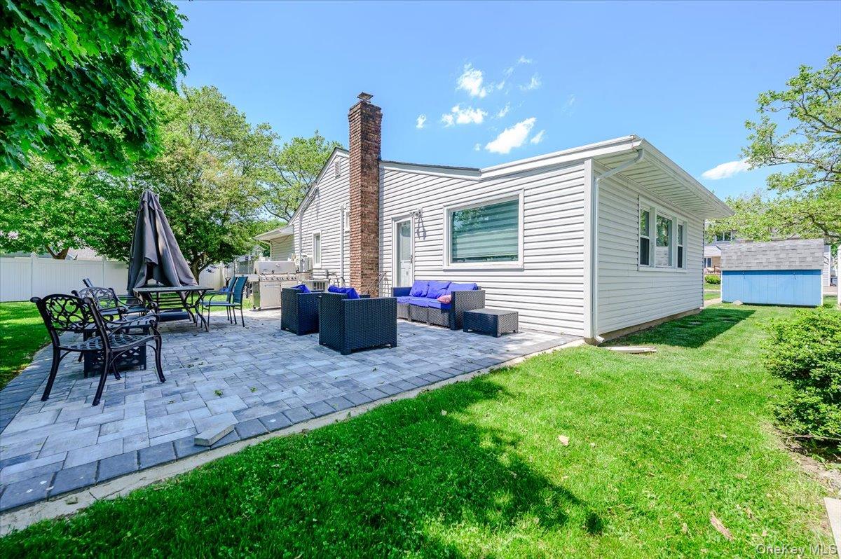534 Allen Road Woodmere, NY 11598 - Photo 24 of 35 a view of a house with backyard and a tree