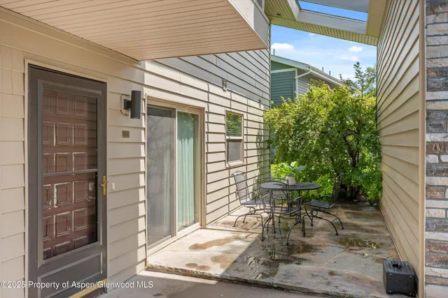a view of a chair and table in the back room