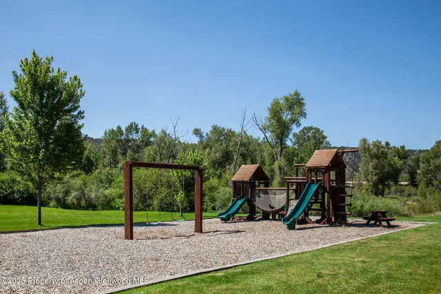 a view of a park with swings and slides