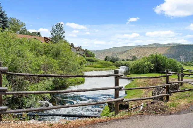 a view of a street with a yard