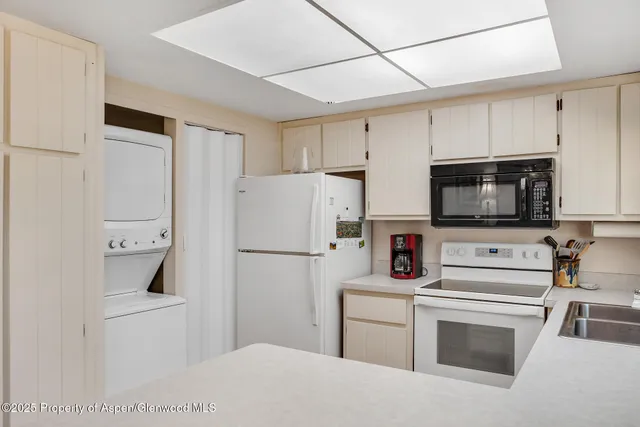 a kitchen with stainless steel appliances a refrigerator stove and microwave