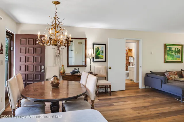 a view of a dining room with furniture and chandelier
