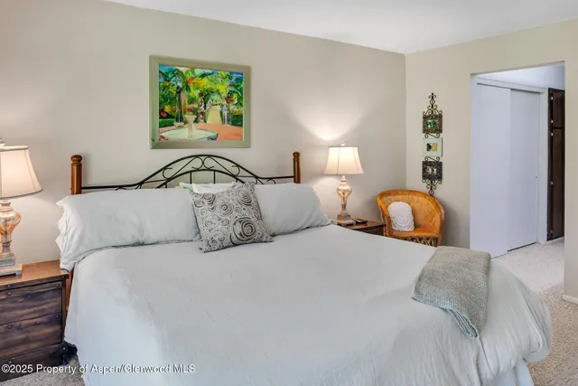 a bedroom with a bed and a large window