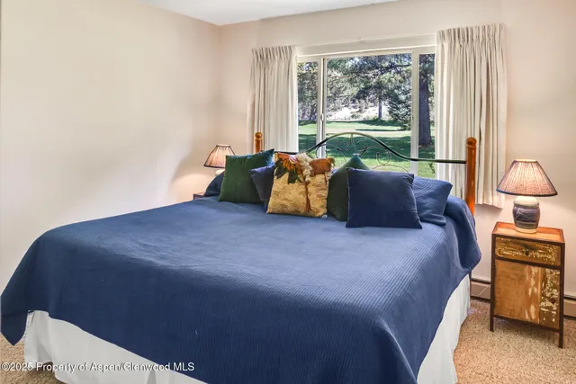 a bed sitting in a bedroom next to a window