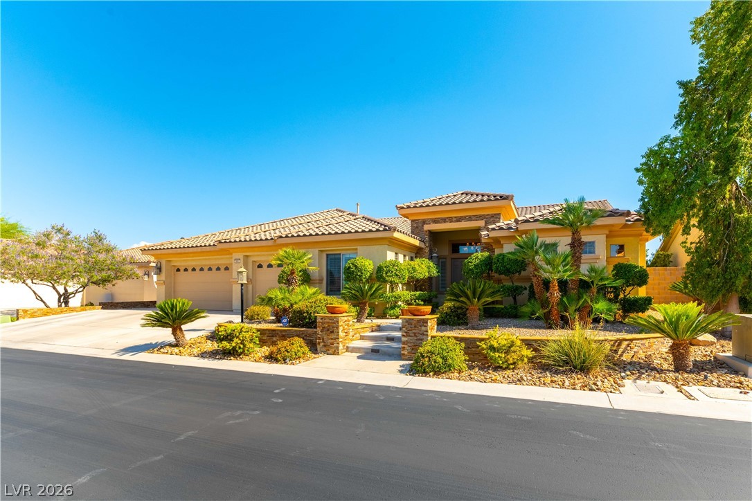 3661 Riley Ann Avenue Las Vegas, NV 89139 - Photo 2 of 42 An inviting exterior with a well-maintained driveway and lush landscaping greets visitors to this residence.