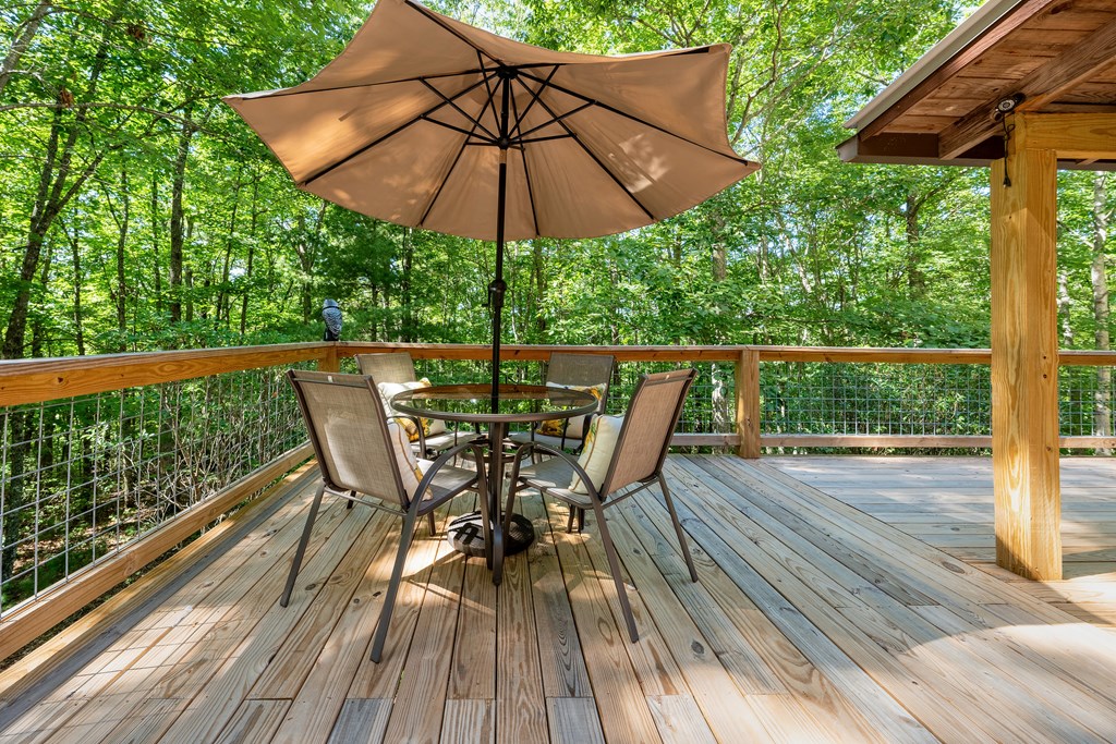 84 Knights Way Blairsville, GA 30512 - Photo 27 of 51 a view of deck with furniture and barbeque oven in the forest