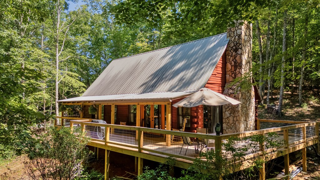 84 Knights Way Blairsville, GA 30512 - Photo 3 of 51 a roof deck with table and chairs under an umbrella