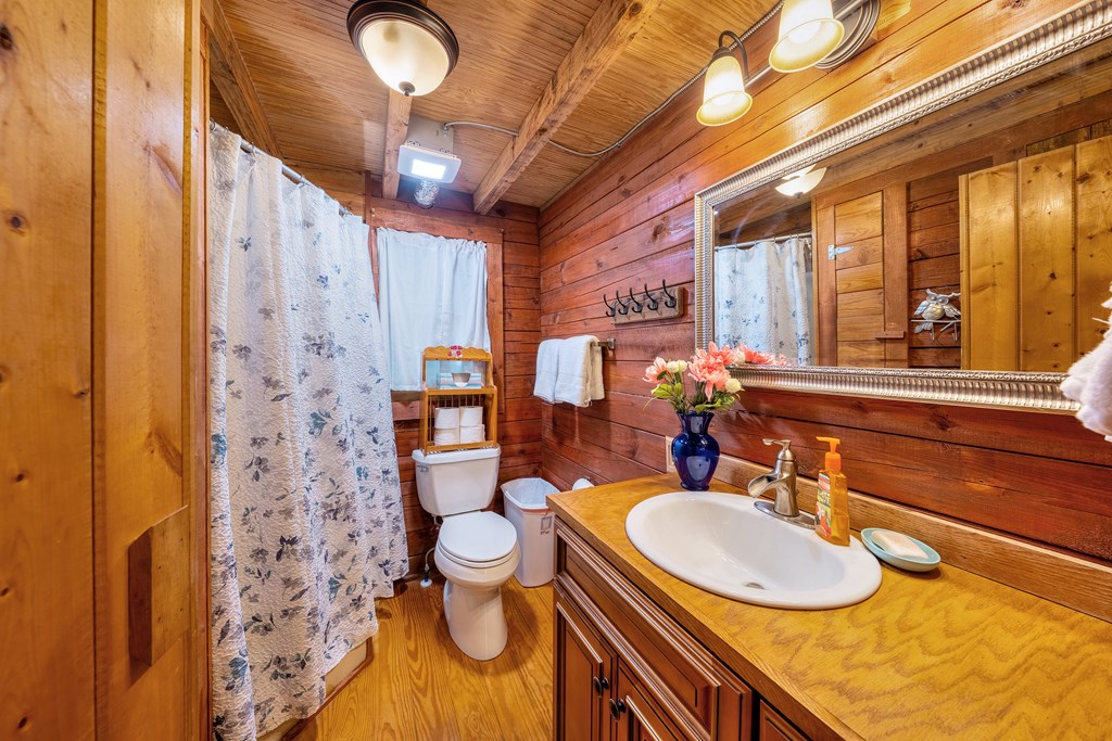 84 Knights Way Blairsville, GA 30512 - Photo 40 of 51 a bathroom with a granite countertop sink and a mirror