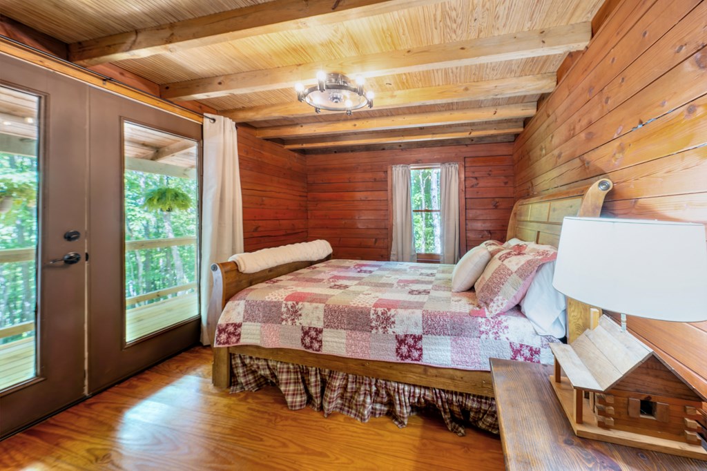 84 Knights Way Blairsville, GA 30512 - Photo 43 of 51 a bedroom with a bed and wooden floor