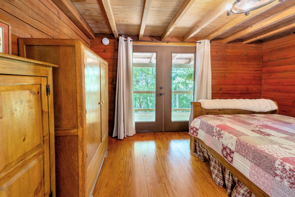 84 Knights Way Blairsville, GA 30512 - Photo 45 of 51 a bedroom with a bed and wooden floor