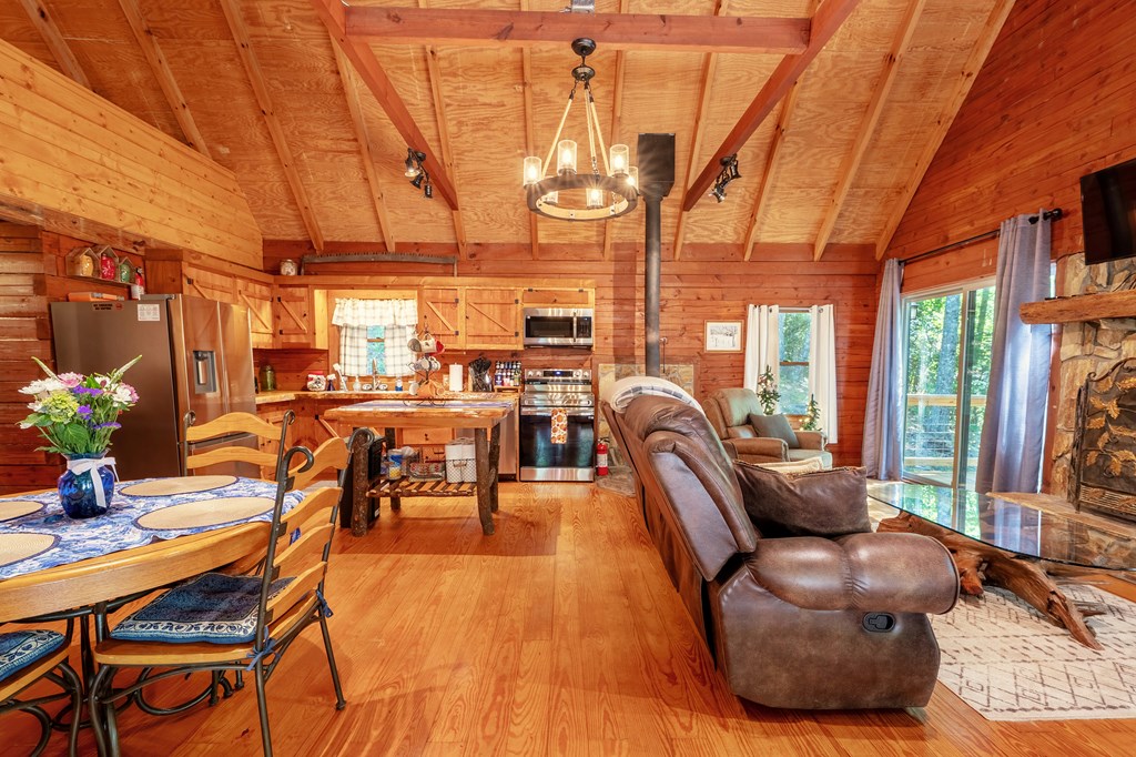84 Knights Way Blairsville, GA 30512 - Photo 6 of 51 a living room with furniture a flat screen tv and floor to ceiling window