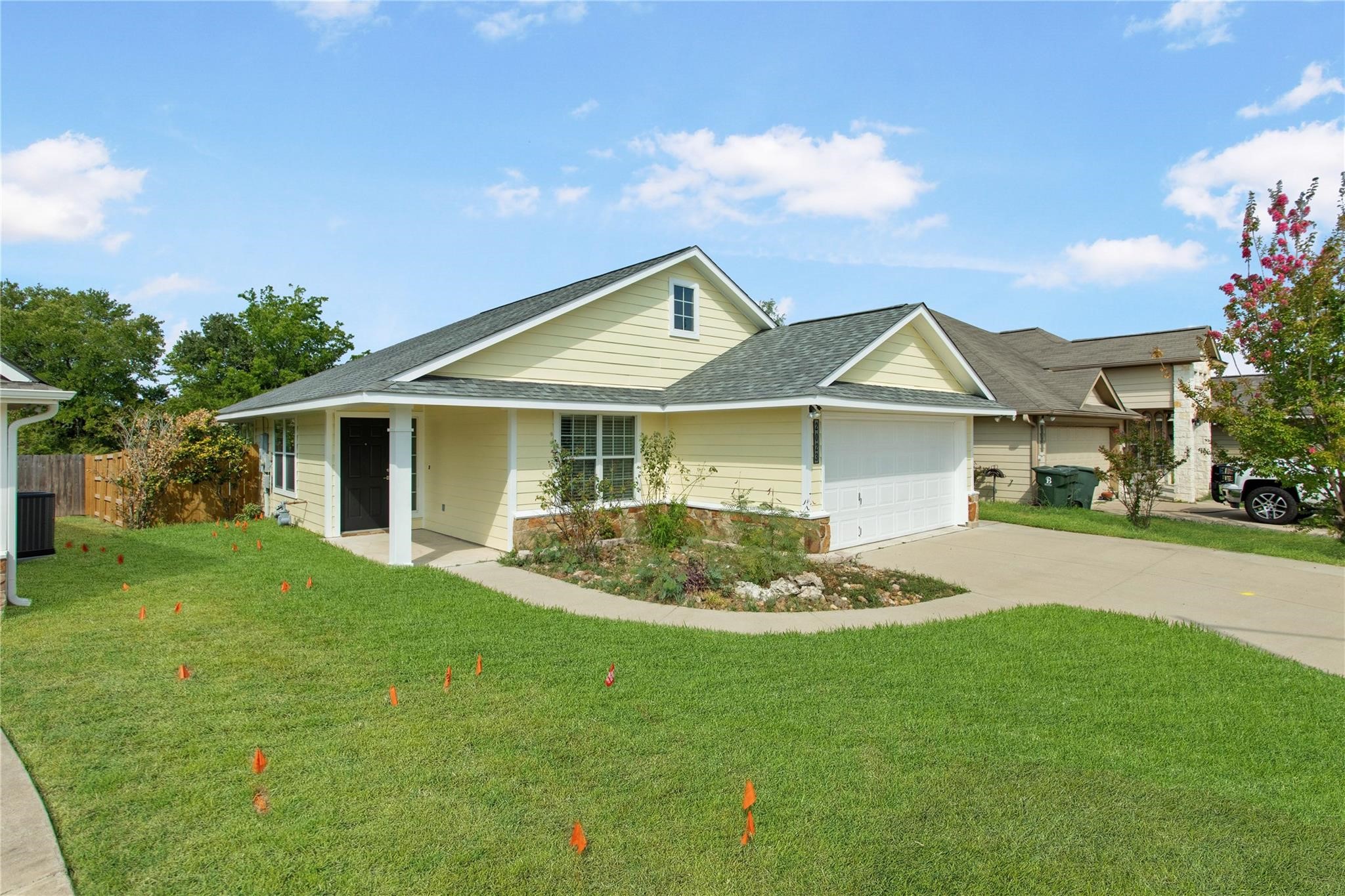 2023 Mountain Wind Loop Bryan, TX 77807 - Photo 2 of 16 a front view of a house with a garden and yard