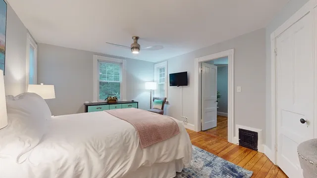 a bedroom with a large bed and a tv