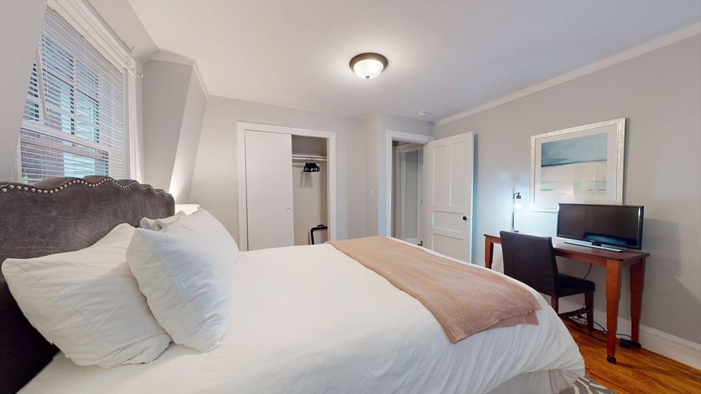 16 Linder Terrace, Unit 2 Newton, MA 02458 - Photo 17 of 22 a bedroom with a bed and a flat screen tv