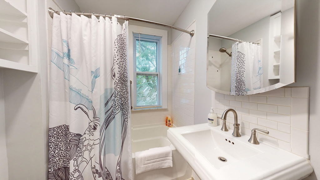 16 Linder Terrace, Unit 2 Newton, MA 02458 - Photo 18 of 22 a bathroom with a sink and a mirror