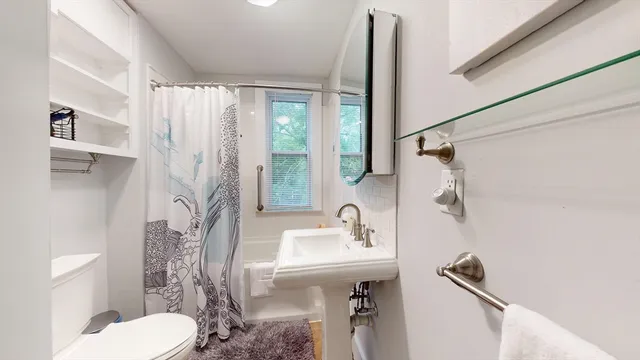 a bathroom with a sink toilet and shower