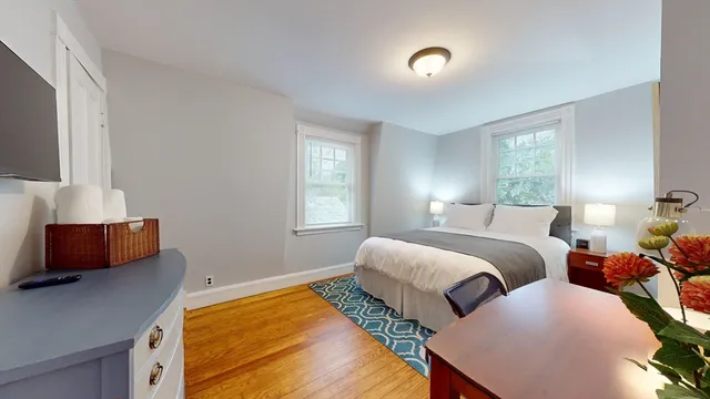 a bedroom with two beds and a window