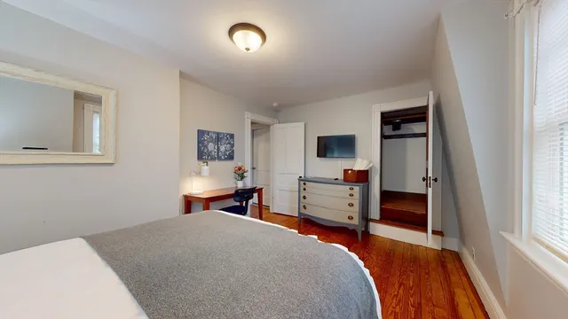 a bedroom with furniture and window