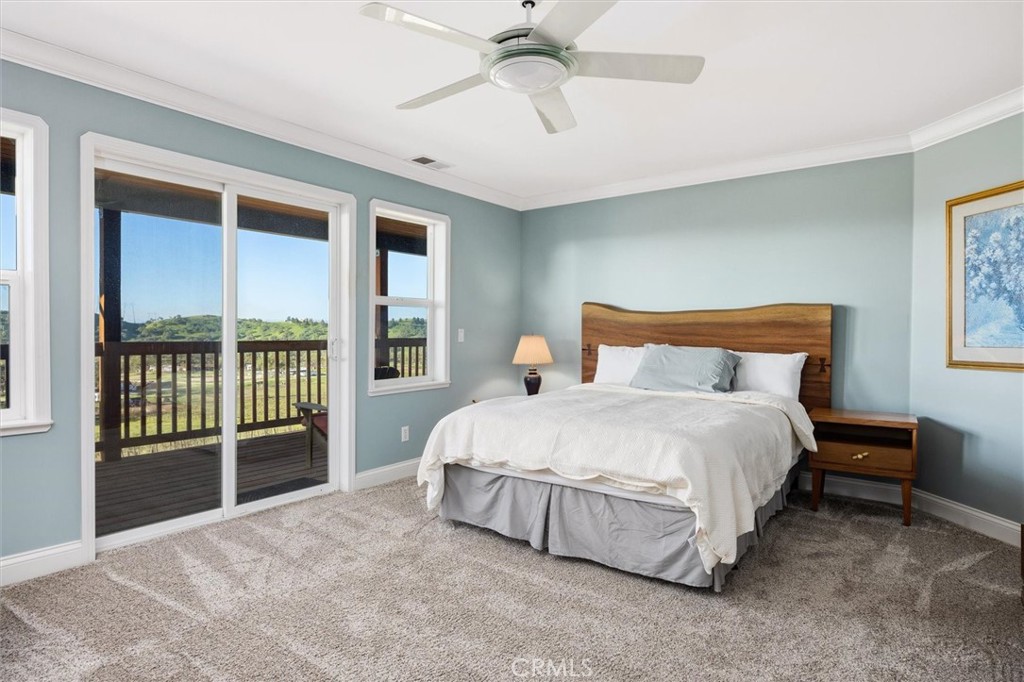 1985 Penman Springs Road Paso Robles, CA 93446 - Photo 18 of 65 a bedroom with a large bed and a chandelier fan