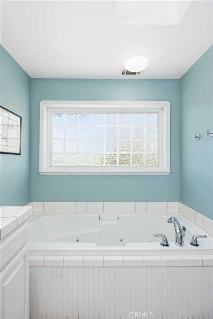 1985 Penman Springs Road Paso Robles, CA 93446 - Photo 23 of 65 a bathroom with a bathtub and a window