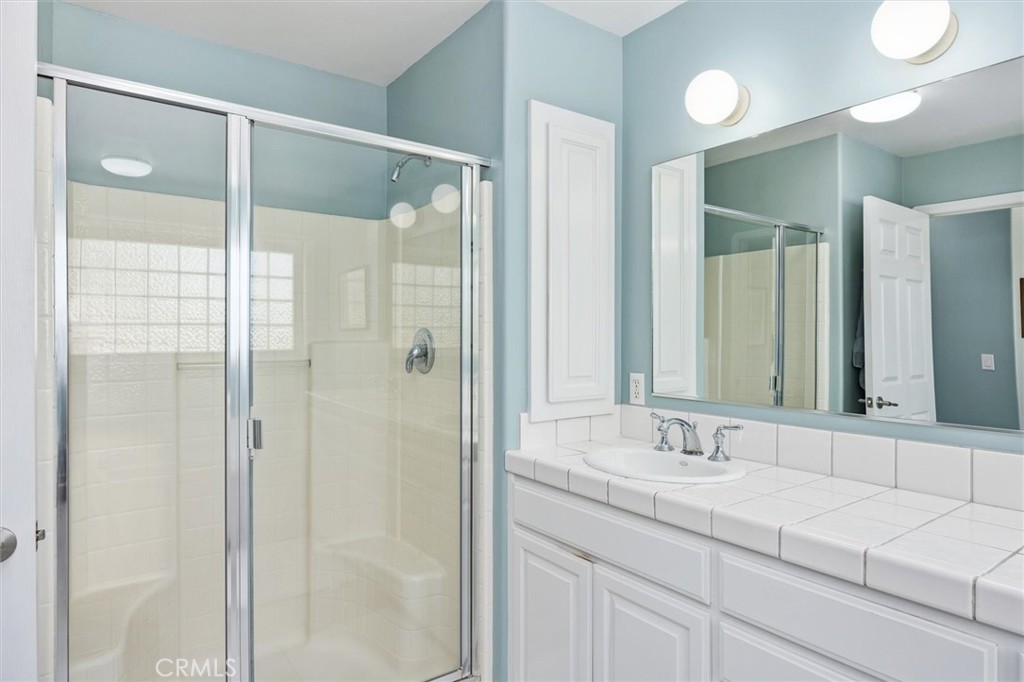 1985 Penman Springs Road Paso Robles, CA 93446 - Photo 24 of 65 a bathroom with a shower sink and mirror