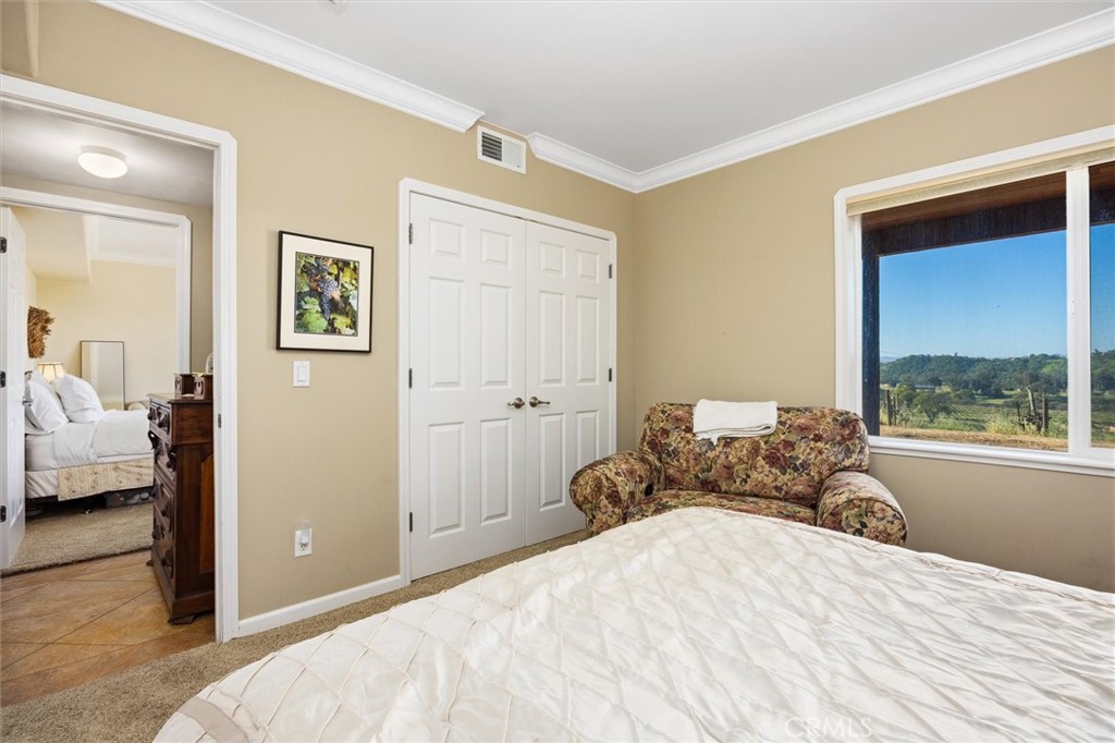 1985 Penman Springs Road Paso Robles, CA 93446 - Photo 27 of 65 a bedroom with a bed and a window
