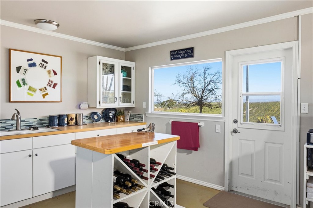 1985 Penman Springs Road Paso Robles, CA 93446 - Photo 42 of 65 a kitchen with stainless steel appliances granite countertop a stove a sink and a refrigerator with wooden floor