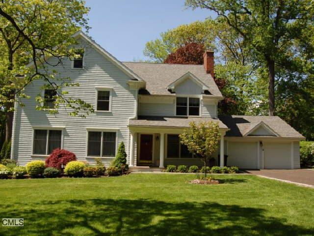 72 Stoneleigh Road Fairfield, CT 06825 - Photo 1 of 1 a front view of a house with a garden and trees