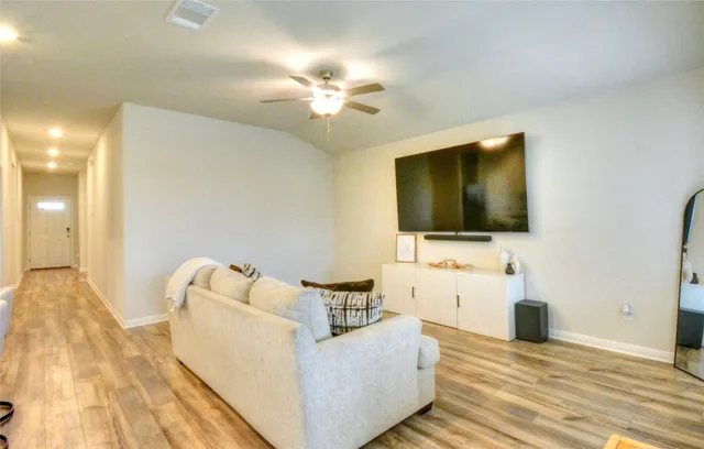 a view of a dining room with furniture and wooden floor