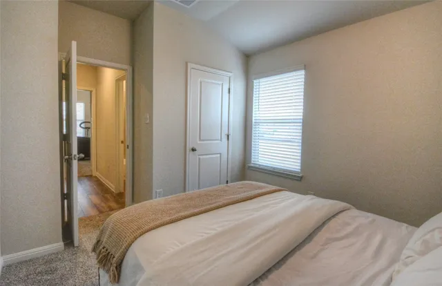 a bedroom with a bed and a mirror