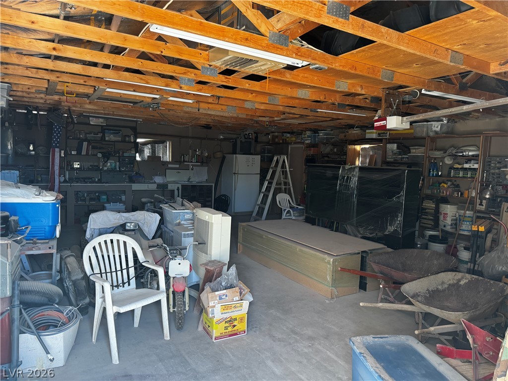 3090 Gally Road Pahrump, NV 89060 - Photo 17 of 20 Functional garage space with exposed wooden beams offers abundant storage potential.