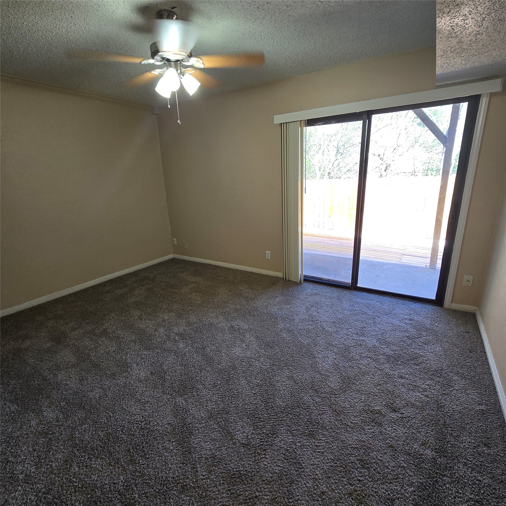 801 Ranch Road 12 San Marcos, TX 78666 - Photo 11 of 21 Spare room featuring ceiling fan, dark carpet, and a textured ceiling
