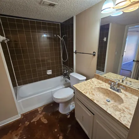 a bathroom with a sink a toilet a mirror and bathtub