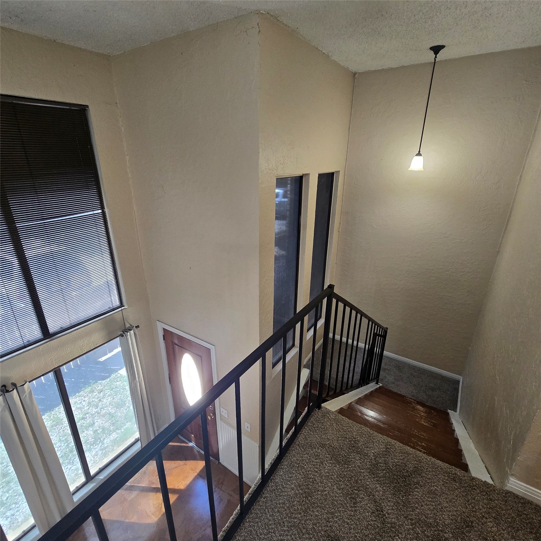 801 Ranch Road 12 San Marcos, TX 78666 - Photo 17 of 21 Stairway with carpet, a textured wall, and a high textured ceiling